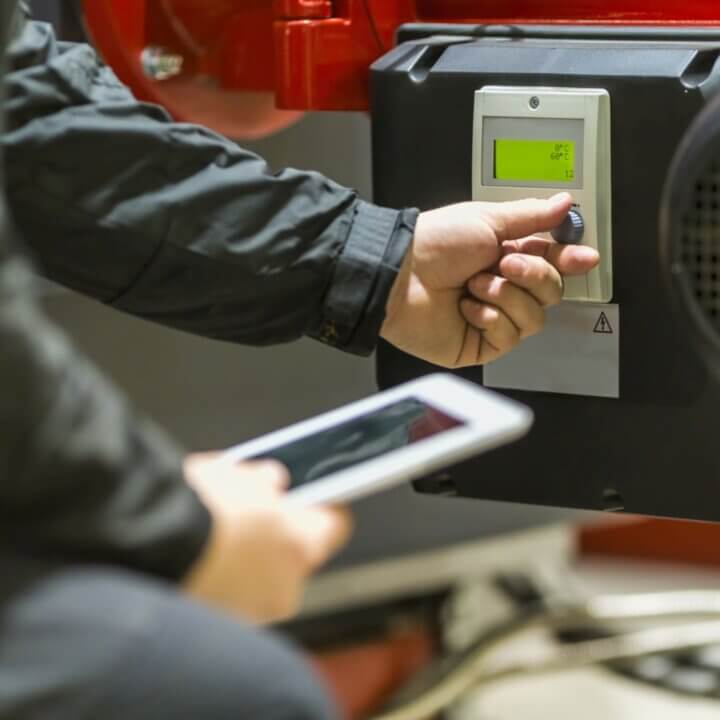 Employee take note in boiler room
